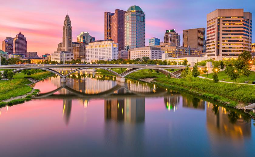 tall city buildings behind bridge and river in downtown columbus 