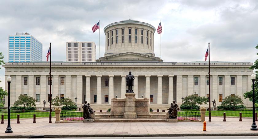 Ohio Statehouse building facade with cloudy sky 