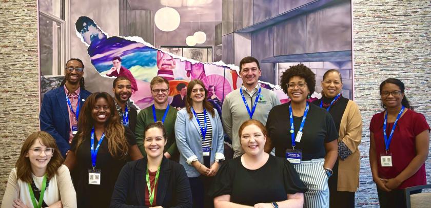 group photo of emerging leaders posing in front of artwork